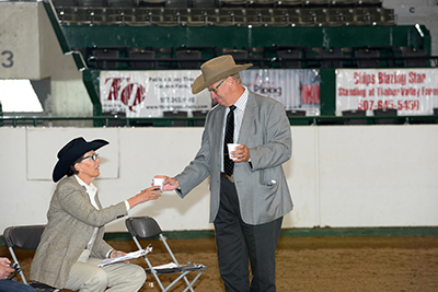 Larry Hansch brings Nancy Sue Ryan a cup of coffee.